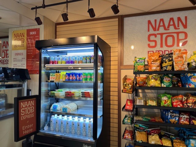 Naan Stop Express storefront with snacks and beverages