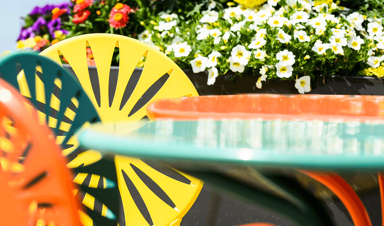 Terrace chairs and tables with flowers in the background