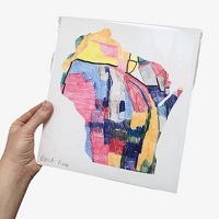 Hand holding a colorful painting of the state of Wisconsin