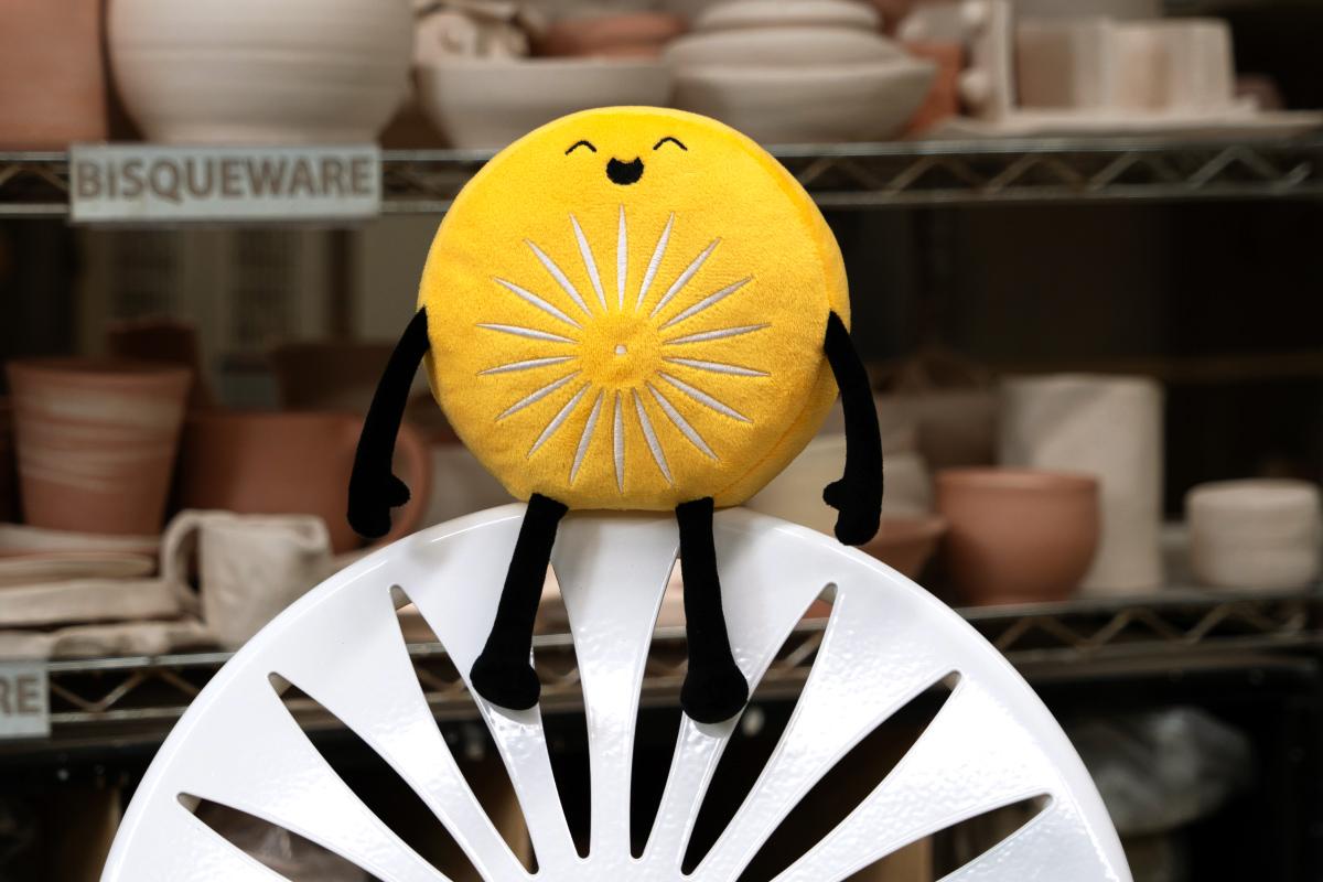 Ray Laken chairling plushie sits atop a Wisconsin Union chair.