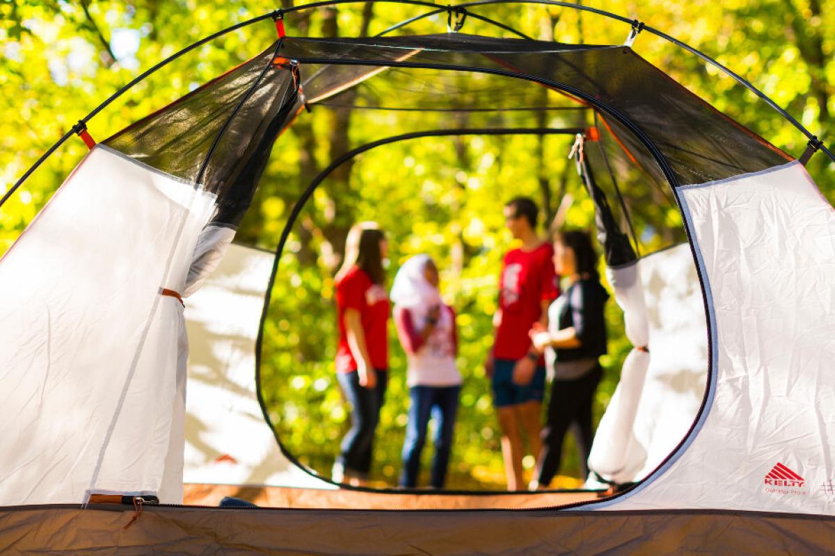 Tent with group of people talking in the background