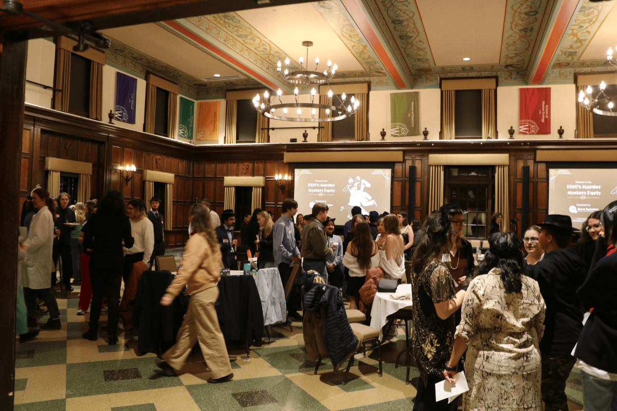 People mingle during a 1920s Murder Mystery game at Tripp Commons