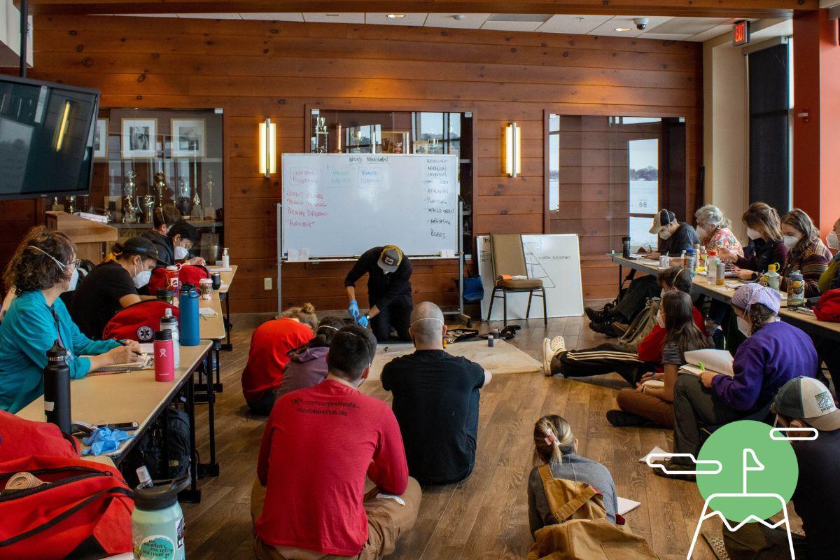 Students observe instructor at an indoor course at Outdoor UW
