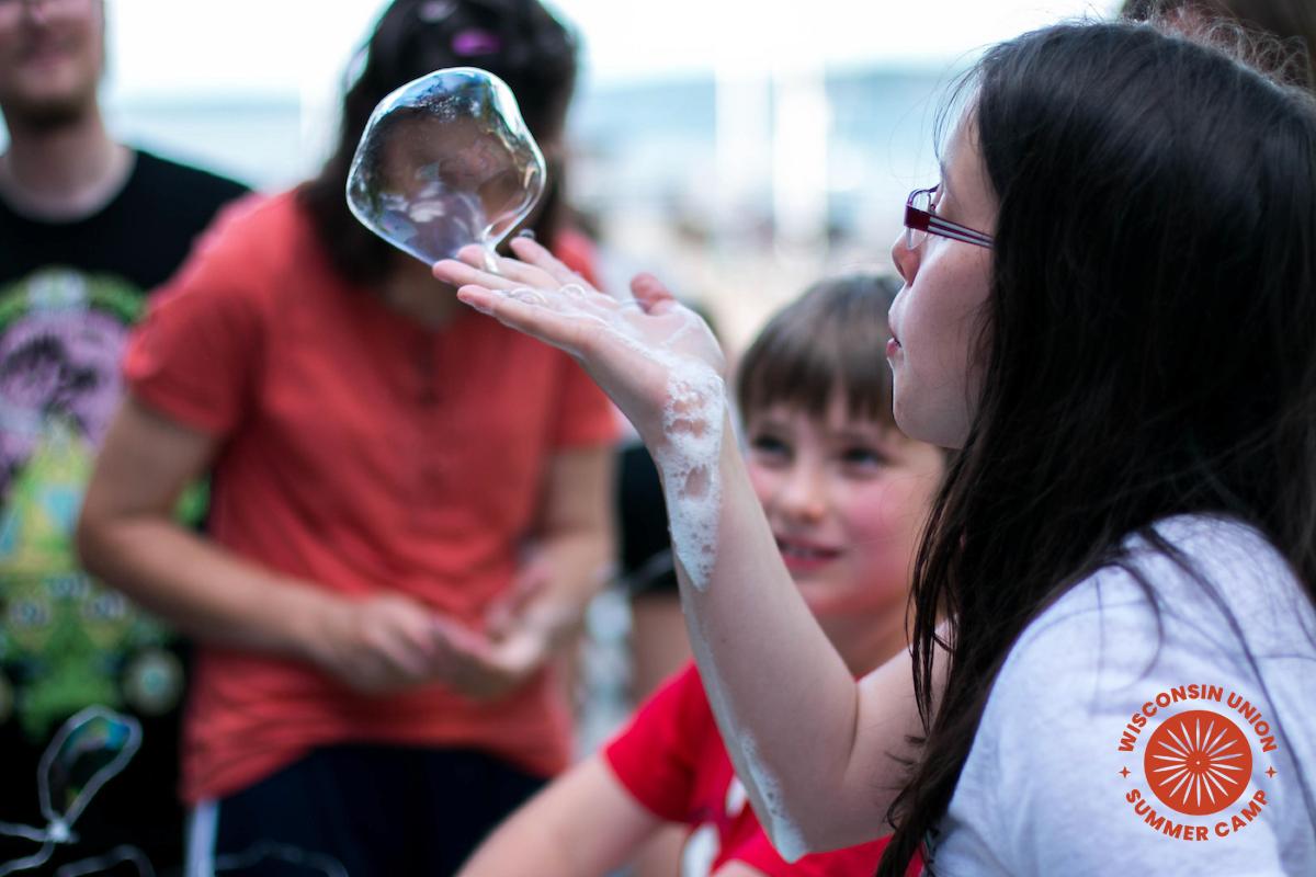Girl catches a bubble in her hand