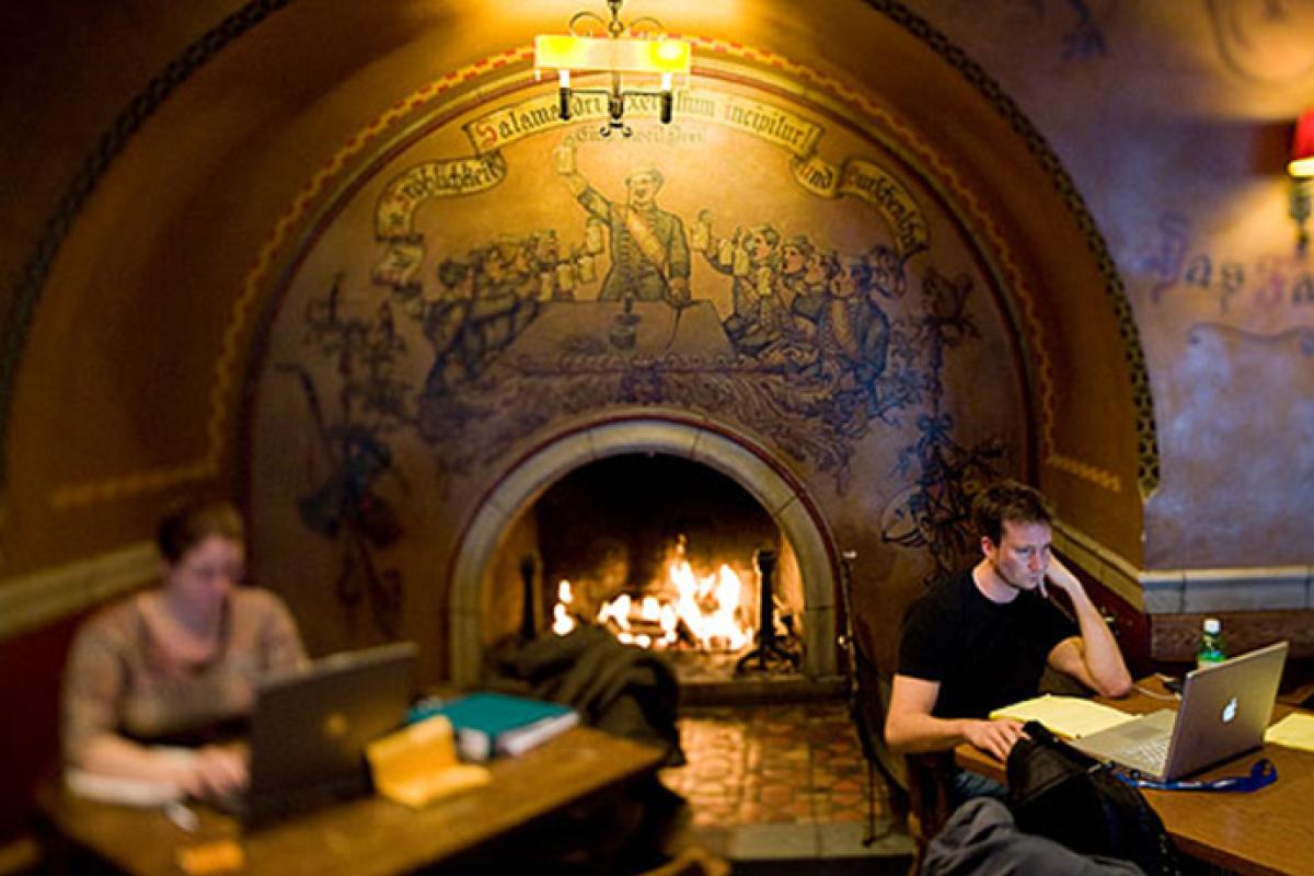 Students studying by the fireplace at Der Rathskeller