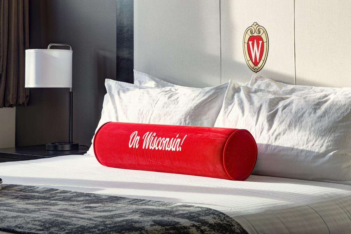 Union South Hotel pillow embroidered with text, &quot;On Wisconsin!&quot;