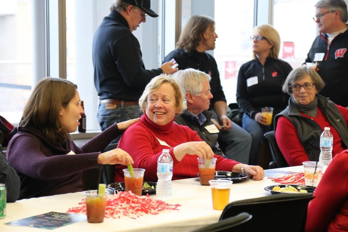 WUA members sitting at a table during a Badger Bash tailgate