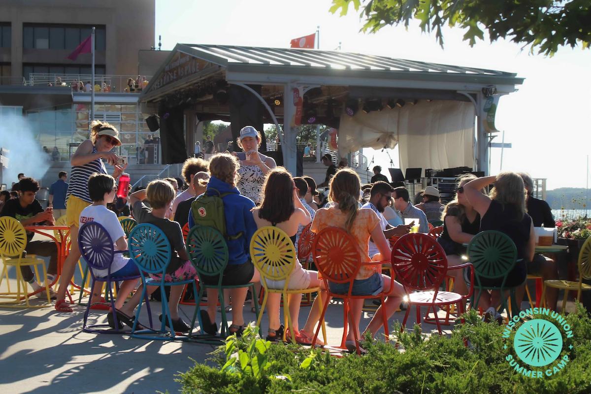 People sitting in multicolor chairs on the Terrace for a photo-op.