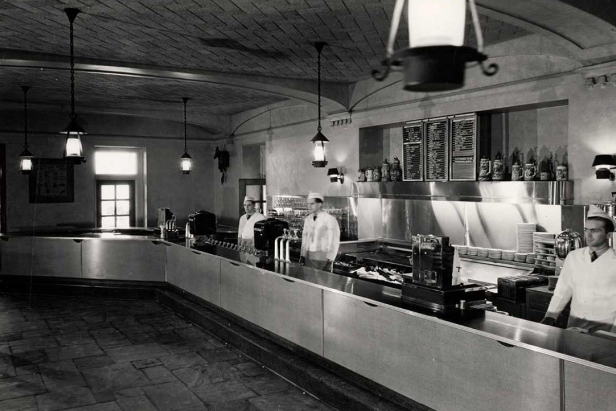 Black and white photo of employees behind the bar at Der Rathskeller