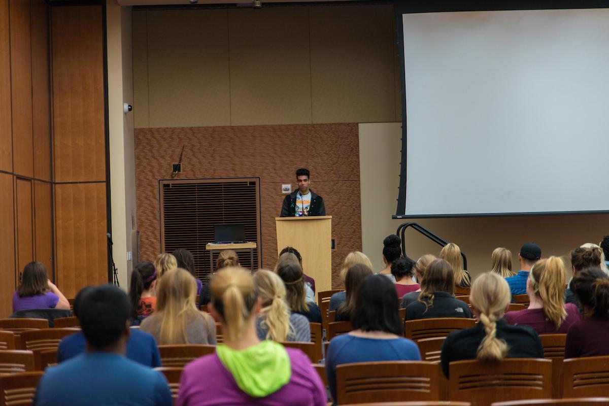Someone speaking at a podium during a WUD Society &amp; Politics event