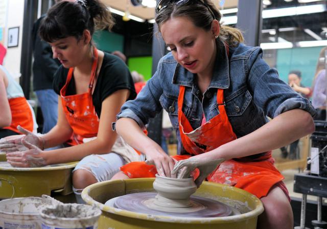 An artist spinning pottery at Wheelhouse Studios