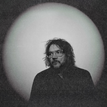 Black and white photo of Jeff Tweedy