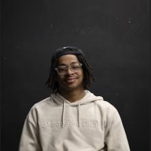 Portrait of Jordan Waters in tan sweatshirt